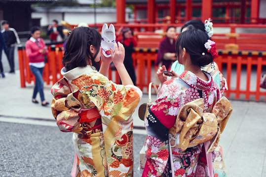 Women in kimono standing outdoors