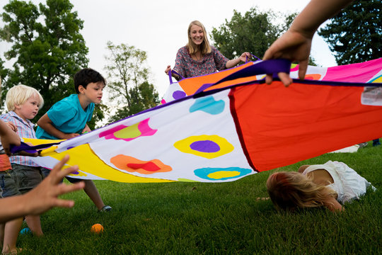 Family playing game with tent fabric
