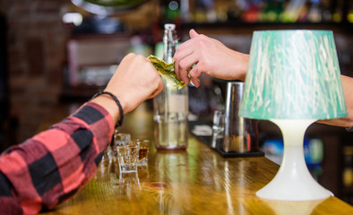 Cash payment. Hand hold dollar money cash at bar counter. Ordering drinks in bar. Purchase and...