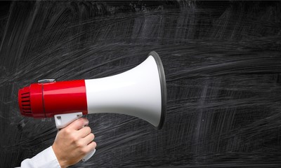 Close-up Human Hand with Megaphone on  background