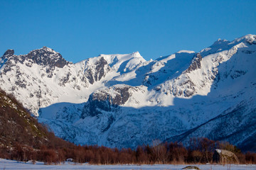 Fototapeta premium Mountains in winter, The mountain Møysalen in 1264 over the sea in Hadsel municipality, Nordland county