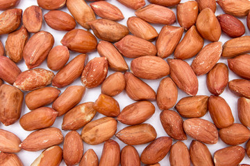 Red peanuts, fried peanuts. Peanuts on white background. Uncleaned peanuts.