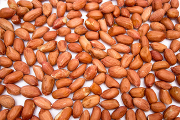Red peanuts, fried peanuts. Peanuts on white background. Uncleaned peanuts.
