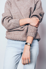 Stylish young woman wearing plain brown sweater