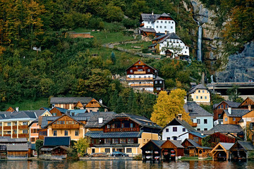 Fototapeta na wymiar Hallstatt austrian alps resort and mountain village with traditional rural alps houses, restaurants, hotels and wooden boat houses at Hallstatt lake. Location: Hallstatt lake, Austria, Alps