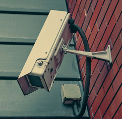 Rustic urban city surveillance cctv video monitoring cameras, spying on civilians. big brother is watching you. A cinematic colour grade for atmosphere.