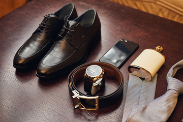 different accessories of a businessman for creating a style of a people lie on a wooden background