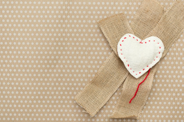 Handmade white heart lies on a vintage background