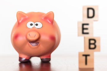 Piggy bank and debt word