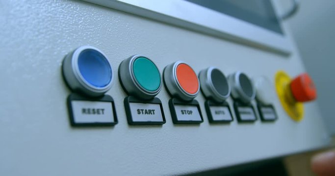 Robotic engineer pushing control panel button