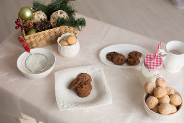 Fototapeta premium new year mood. glass of milk. cookie. Christmas gingerbread. gingerbread with milk. flour sieve