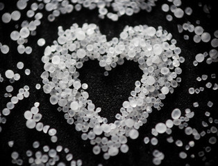 heart of salt crystals on a dark background