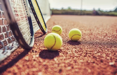 Rolgordijnen Tennis ball with racket on the tennis court. Sport, recreation concept © bobex73