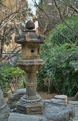 Ancient Stone Incense burner in a quiet meditation garden