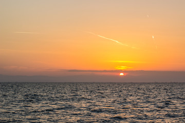 idyllic ocean background landscape horizon line board between water surface and orange sunset romantic sky wallpaper post card pattern with empty copy space for your text or inscription 