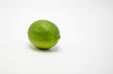 one ripe green lime isolated on white
