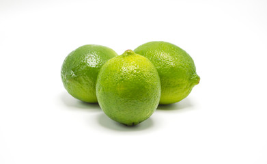 three ripe green limes isolated on white