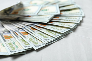 Many dollar banknotes on table, closeup view