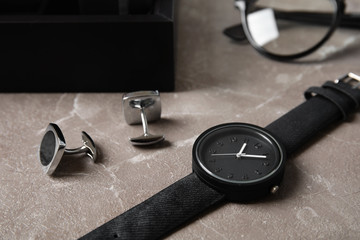 Naklejka na ściany i meble Stylish wrist watch and cuff links on table. Fashion accessory