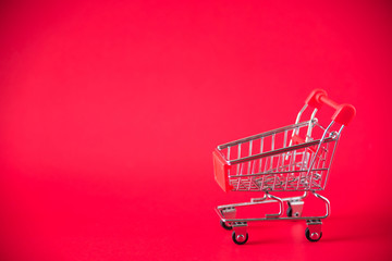 mini shopping cart on red background