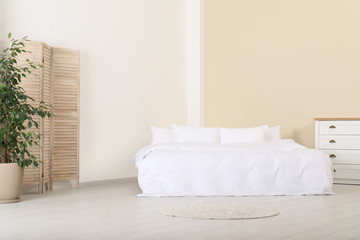 Fototapeta na wymiar Stylish room interior with comfortable double bed