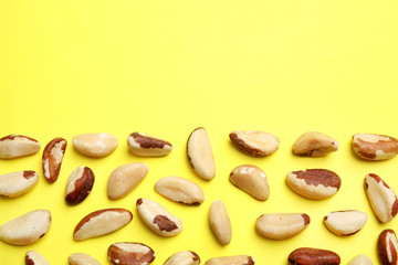 Flat lay composition with Brazil nuts and space for text on color background