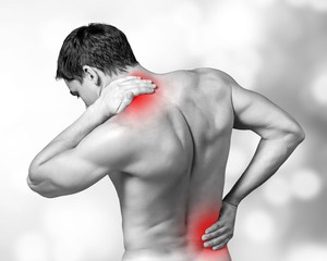 Strong man with neck pain, back view