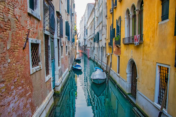 Fototapeta na wymiar View of Canal with boats in Venice, Italy. Venice is a popular tourist destination of Europe.