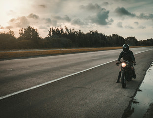 man riding bike on country road