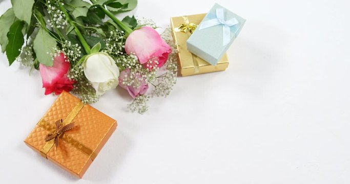 Golden gift boxes and bouquet of roses