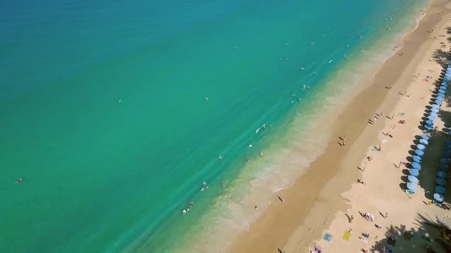 slide down a sunny day at karon beach in phuket thailand