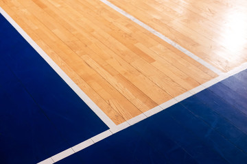 Close-up wooden basketball, volleyball, badminton court background. Sports hall with colorful marking lines. Old school, university gym with marking lines line. Indoor sports playground