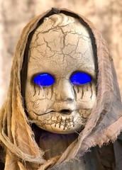 Close view of spooky Halloween doll with glowing blue eyes