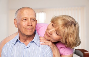 Portrait of happy senior couple smiling at home