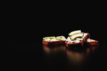 Fresh and healthy food. Snack or lunch ideas. Homemade bread with cheese, avocado and brussel sprout stand on the table