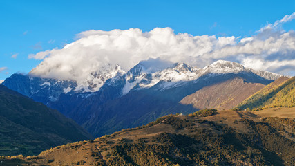 Beautiful snow mountains covered with white clouds. Landscape of China Sichuan 