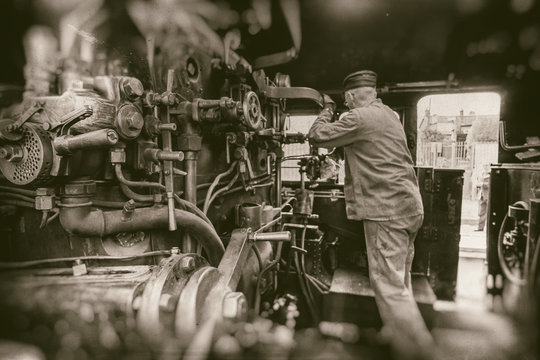 Railway Man Working On Steam Train Engine  - Retro Photography