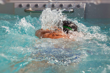 man swimming crawl against the tide in a jacuzzi