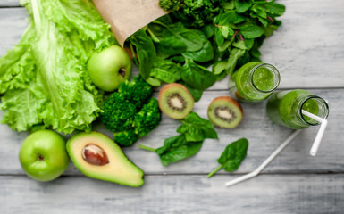smoothie with vegetables, avocado, apple, kiwi on a wooden background. sports nutrition