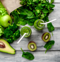 smoothie with vegetables, avocado, apple, kiwi on a wooden background. sports nutrition