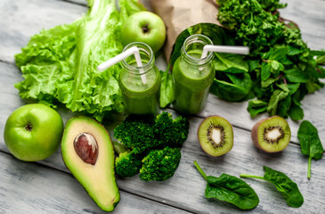 smoothie with vegetables, avocado, apple, kiwi on a wooden background. sports nutrition