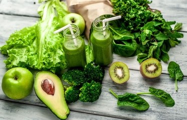 smoothie with vegetables, avocado, apple, kiwi on a wooden background. sports nutrition