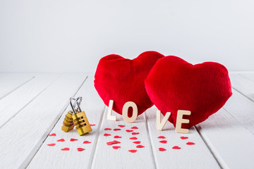 Valentines Day background with Red Heart shape and Couple Combination golden padlock on white wooden table