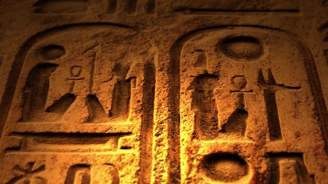 Ancient Egyptian Symbol of ten commandments or another object of ancient origin lit by candle ALT