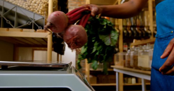 Male staff weighing beets on weighing machine 