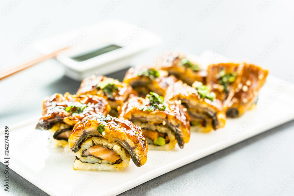 Wall mural Grilled eel or unagi fish sushi maki roll with sweet sauce