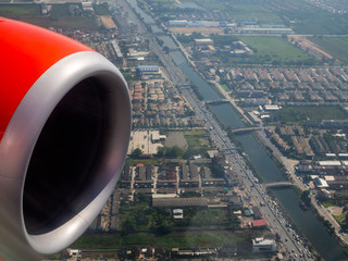 Jet engine of red airplane from window of passenger view