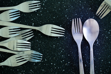 A pair of cutlery and a fork without a pair