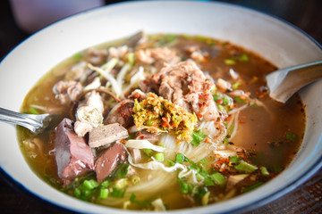 delicious noodles bowl vermicelli noodles soup spicy with pork stew blood cubes and vegetable in bowl