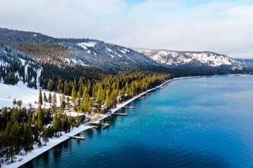 Lake Tahoe Shoreline With Snow Covered Mountains